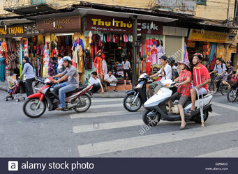 hanoi-vietnam-street-scene-at-a-road-junction-D29MCC.jpeg
